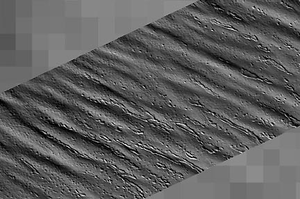 These three photographs in sequence range from a wide shot of the grooves in the Martian south pole, to medium close on two of the parallel grooves, to an extreme close-up of three of the grooves. Photographs courtesy JPL and Malin Space Science Systems.