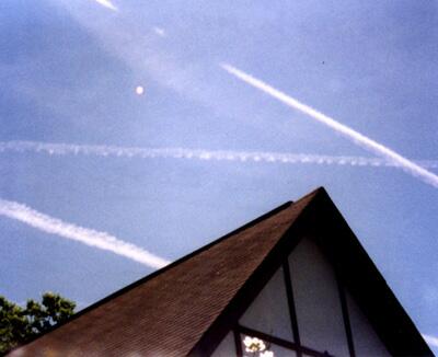Glowing round object and x-shaped contrails in Vernon, New Jersey on May 14, 1999 at 3:30 p.m. EST. Photograph © 1999 by Ed davieau.