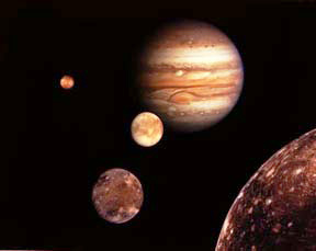 Huge Jupiter, largest planet in our solar system, in illustration of its four largest “Galilean moons” discovered by Galileo (today 49 moons are known) from back to front: smaller, volcanic Io; icy, watery Europa; Ganymede, biggest moon in our solar system, that might have an ocean, too; and battered Callisto. Frictional movements in the crusts of the moons caused by massive Jupiter's gravitational stretches and pulls are what keep Io's hot liquid core erupting and Europa's deep ocean warm enough to stay liquid.