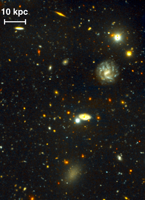 Dragonfly 44 is the faint greyish-green “smudge” in the bottom of these two images taken by the Dragonfly Telescope in Cloudcroft, New Mexico. Dragonfly 44 was the 44th faint object discovered in Prof. Pieter van Dokkum's research at Yale University and turned out to be the first galaxy of its kind ever found: 99.99% dark matter. Images by van Dokkum/Dragonfly Telescope.