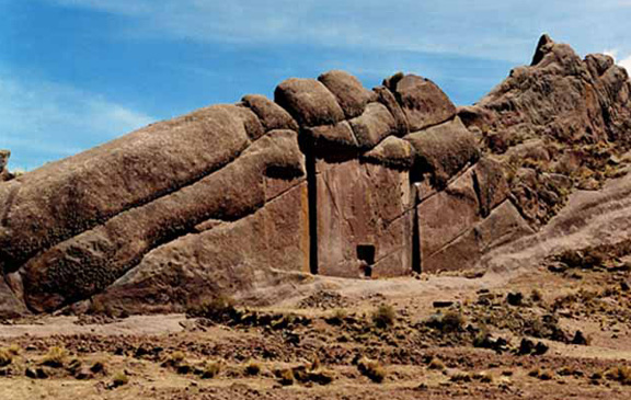 The door shape carved in the solid rock wall known as Aramu Muru at its widest and highest is 23 feet. The location is on the southwestern edge of Lake Titicaca, Peru, near the Bolivian border. The local native Indians say it is “Puerta de Hayu Marca," a gateway to the lands of the Gods and immortal life. Sometimes those who have gone through the doorway return with their “gods to inspect all lands in the kingdom” through the Aramu Muru door. Image by Ancient-Wisdom.com.