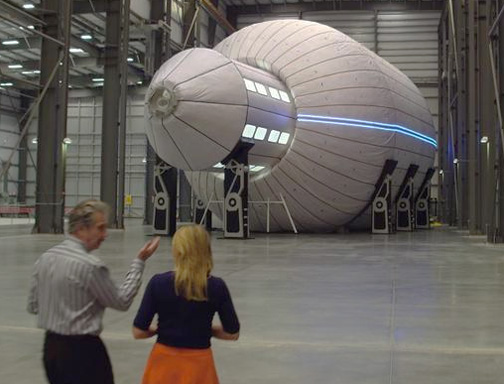 Robert Bigelow, Founder of Bigelow Aerospace in Las Vegas, talking with CBS 60 Minutes corresponent Lara Logan as they stand in front of Bigelow's largest expandable spacecraft, The Olympus, which he calls “a mansion for the skies.” May 28, 2016, 60 Minutes image source CBS News.