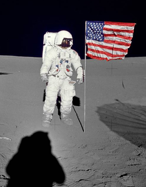 Astronaut Edgar D. Mitchell, Apollo 14 lunar module pilot stands by the deployed U.S. flag on the lunar surface during the early moments of the mission's first spacewalk. He was photographed by astronaut Alan B. Shepard Jr., mission commander. Astronaut Stuart A. Roosa, command module pilot, remained with the Command and Service Module "Kitty Hawk" in lunar orbit. Credit: NASA.