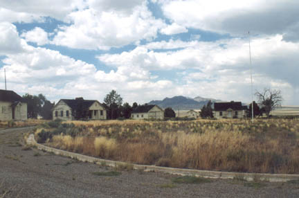 Weed-filled circular driveway ringed by deteriorating DRES buildings and empty flagpole. July 17, 2005 photograph © by Linda Moulton Howe.