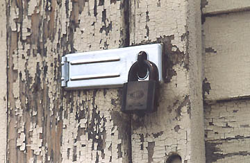New lock hardware on peeling paint at DRES, July 17, 2005. Photograph © by Linda Moulton Howe.