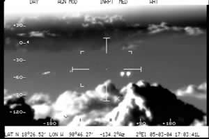 March 5, 2004, at 5:03:41 p.m. local time,"White hot" polarity, FLIR (Forward Looking Infrared) StarSAFIRE II.Unidentified objects near cross hairs. Cumulus clouds up to 21,000 feet; Mexican Air Force plane flying at 11,480 feet. All FLIR video images from infrared videotape courtesy Mexico Department of Defense.