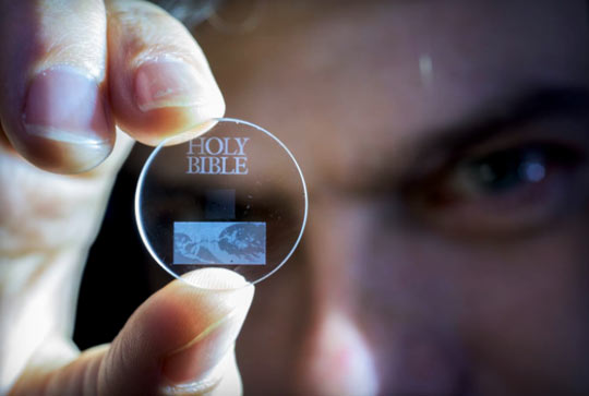 This one-inch 5-dimensional data storage glass disc contains the King James Bible. A 5D glass disc the size of a 128-gigabyte Blu-ray can store 360 terabytes of information. So the 5D glass disc could store 3,000 times more than the Blu-ray disc. Image by U. K.'s University of Southampton.