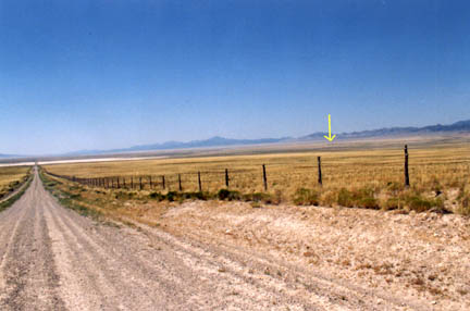 Road and 1933-built fence to lakebed triangle. Arrow points to DRES. Photograph © 2005 by Linda Moulton Howe.