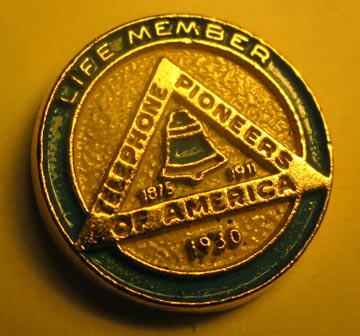 Life Member Telephone Pioneers of America pin worn by John Smith's father. Telephone Pioneers of America was founded in Boston in 1911 with 734 members, including Alexander Graham Bell, who received membership card No. 1. AT&T's Henry Pope wanted to inspire the science and technology of telephones for those scientists and engineers  devoted to the industry. Image © 2012 by "John Smith."
