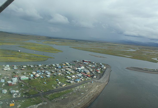 Native Village of Unalakleet, Alaska, which in Inupiat language means literally “winds coming from the East,” as storm clouds above came from the east with rain. Image courtesy NOAA 2010.
