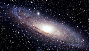 The Andromeda Galaxy is a large spiral galaxy very similar to our own Galaxy, the Milky Way. It is over 65,000 light-years in diameter and approximately 2.2 million light-years away from Earth. From Earth to the center of our Milky Way Galaxy is 8,500 parsecs ­ about 26,000 light years ­ the densest region. Andromeda image by T.A.Rector and B.A.Wolpa/NOAO/AURA/NSF. 