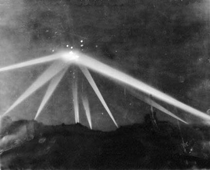 Actual photograph taken of eight search lights aimed by American anti-aircraft batteries at an unidentified object or objects during the “Battle of Los Angeles” some time after 3:06 a.m. Pacific, February 25, 1942, over Santa Monica Mountains near Los Angeles, California. Photographer, Mr. Calvert.