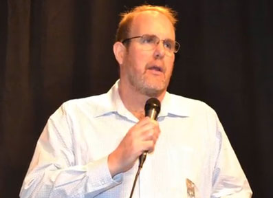 John Burroughs receiving 2015 Researcher of the Year Award for FOIA breakthroughs with the U. K. Ministry of Defence about the MoD's withholding UAP/UFO files, on February 21, 2015, Open Minds Conference, Fountain Hills, Arizona.