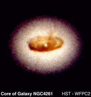 An example of a likely black hole. This is a 1997 Hubble Space Telescope image of a suspected black hole at the center of galaxy NGC4261. Inside the white galactic core, there is a brown spiral-shaped disk. The dark object is about as large as our solar system, but weighs 1,200,000,000 times as much as our sun. That means the dark object's gravity is about one million times as strong as the sun. "Almost certainly this object is a black hole," reported Britain's Cambridge University. Photograph courtesy of Hubble Space Telescope. 