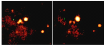 Bright, near-white, oval X-ray image at center of frame on right is recent of the central region of a galaxy called M82 compared to image on left taken in June 2000. The anomalous V-shaped brightening in the left frame is a transitory intensity of x-rays that are unidentified but typical of x-ray fluctuations. Chandra X-ray Observatory images courtesy of NASA/SAO/CXC.