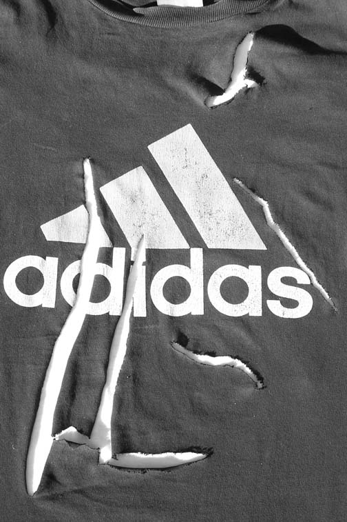 The five slices in the Adidas T-shirt Evan was wearing on September 11, 2006,  when a fifth non-human entity with curved blade-like fingers grabbed Evan from behind before he fell unconscious to the corral ground. Image © 2006 by Richard Moss and Lorna Hunter.