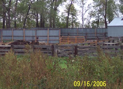 Orange gate of pig corral. Evan went in with his .22 and shot one of the non-human creatures dragging the dead pet sow.