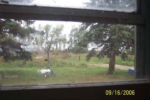 Above: Evan's point of view looking out kitchen window around 1 a.m. on September 11, 2006. Below: Just beyond trees are the large corral; long, gray barn; and small pig corral at far end of barn surrounded by sheet metal walls and marked by pink circle. Images © 2006 by Richard Moss and Lorna Hunter.