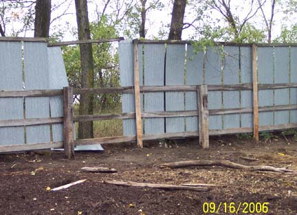 Above:  Sheet metal panels were broken out from pig corral wall. Below: Evidence of force at nail holes? Images © 2006 by Richard Moss and Lorna Hunter.