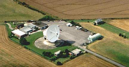 Chilbolton Observatory, a British government-owned facility, was originally constructed in 1965 to study radio wave propagations from space and satellites. The Observatory is off limits from the public. The wheat field that runs along its boundary, as shown in above photograph, is privately owned and operated by the Leckford Estate. Aerial photograph © 2001 by Lucy Pringle.