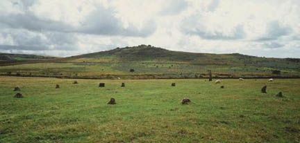 Megalithic Mysteries describes the ancient Merrivale Stone Circle in Tavistock near Dartmoor where sheep graze: "Eleven stones in a circle varying in height from 30cm (1 foot) to 50cm (1 foot 6 inches). It is a flattened circle measuring 20.5m (67 feet 5 inches) E-W by 17.8m (58 feet 5 inches). A 3m (10-foot 4-inch) tall, slender stone stands at an azimuth of 182 degrees from the centre of the circle, suggesting an attempt for cardinal-point alignment. The axis of the ring is 88 degrees - 268 degrees, a similar suggested alignment." Photo © by Megalithic Mysteries. 