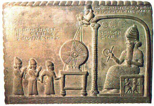 The tall humanoid on the right holding the rod and coil is the Annunaki Shamash or Sama, also known as the Sumerian sun-god, Utu, in Babylonia and Assyria. On the left are smaller humanoids figures in the alien-human hybrid service category.