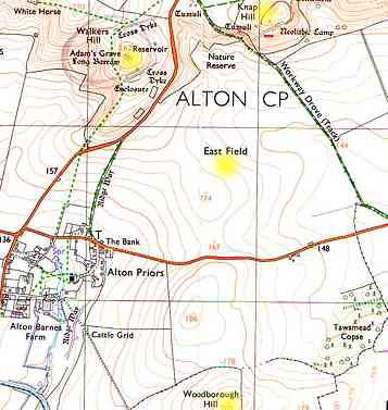 The large East Field in Wiltshire, England spreads out below Adam's Grave and Knap Hill. Across the road to the south is Woodborough Hill and Tawsmead Copse. Since the modern crop formation phenomenon began in 1989, this geography has become legendary for mysterious lights and interactions with helicopters. 