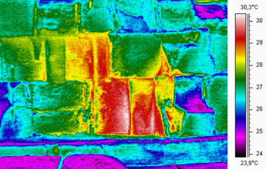 This thermal scan shows that the temperature of three limestone blocks at ground level on the eastern facing side of the Great Pyramid is elevated by a few degrees, see scale on the right. Researchers say cause could be internal air currents, differences in the limestone or by an opening behind the wall. Thermal image courtesy Scan Pyramids.