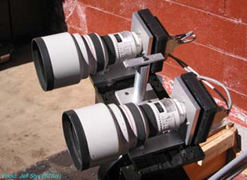 Astronomers used this inexpensive telescope to find an extrasolar planet transiting the face of a Sun-like star 600 light-years from Earth. The telescope, which looks like a pair of binoculars, consists of two 200-millimeter telephoto camera lenses. The lenses are attached to electronic device s that measured slight dips in light output from the star, indicating that an object was crossing in front of it. The telescope is on the summit of the Haleakala volcano in Hawaii. Research team members are from the Space Telescope Science Institute; Rice University; Boston University; University of Hawaii; University of Illinois; University of Florida; Boston University; Racoon Run Observatory; Hereford Arizona Observatory; CBA Belgium Observatory.