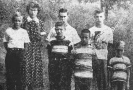 Flatwoods, West Virginia, eyewitnesses who saw 'monster' on September 12, 1952. Back row: Freddie May (11-years-old); Mrs. Kathleen May (Freddie's mother); Gene Lemon, Neil Nunley (14-years-old). Front row: Edison May (13-years-old); Theodore Neal (13-years-old); Ronnie Shaver (10-years-old). This photograph was taken on September 20, 1952 © by Lee Stewart, Jr.