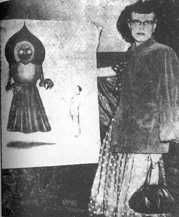 September 12, 1952, eyewitness Kathleen May, mother of Freddie and Edison May, standing next to 1952 television sketch artist's drawing of the "Flatwoods Monster" for use in the TV program, We The People. Photograph courtesy Kathleen May in Frank Feschino's book, The Braxton County Monster: The Cover-Up of the Flatwoods Monster Revealed © 2004.