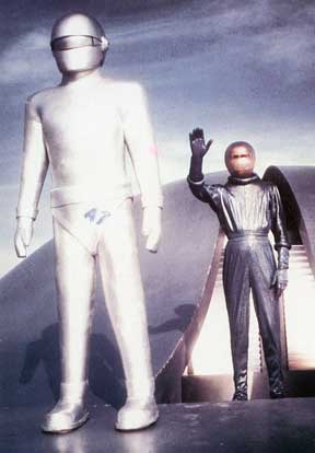 Postcard front scene from The Day the Earth Stood Still released in 1951 by 20th Century-Fox Film Corp. An extraterrestrial humanoid, Klaatu, (hand up) landed on Earth with a powerful robot, Gort, to deliver a warning that humans will not be allowed to spread their violence into space.