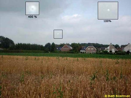 Three "balls of light" above the Hoeven, Holland, wheat circle on July 23, 2004, during investigation by Robert Boerman of DCCA and his son, Bart. Digital photograph © 2004 by Bart Boerman.