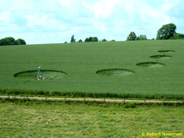 Five circles ranging in size from about thirteen meters to about five meters ascended the hill of a wheat field in Valkenburg, Holland, first discovered in mid-June 2004. Photograph © 2004 by Robert Boerman.