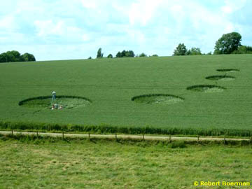 Five circles ranging in size from about thirteen meters to about five meters ascended the hill of a wheat field in Valkenburg, Holland, first discovered in mid-June 2004. Photograph © 2004 by Robert Boerman.