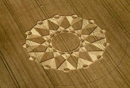 Above: West Stowell, near Huish, Wiltshire, England, 13-fold geometry reported in wheat field on July 20, 2003. Approximately 200 feet in diameter. Photograph © 2003 by Steve Alexander. Below: Close-up of the 13 elaborately twisted small "sculptures' in each of the triangular sections extending from the large central circle. Aerial photographs © 2003 by Nick Nicholson and Cropcircleconnector.com.
