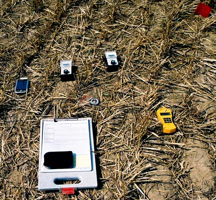 Left to right: New magnetometer, Broadband TriField EM Meter, Natural TriField EM meter, compass, and Gamma-Scout near the center of the main circle. The circle center was marked with the red flag in upper right corner of this photo. Image © 2006 by ICCRA.