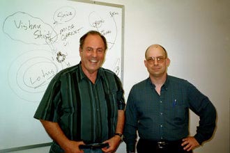 On right, Dan B Burisch, Ph.D., Microbiologist, with Bill Hamilton on left, in front of drawing board in 2002, Las Vegas, Nevada. Photograph © 2002 by Bill Hamilton. 