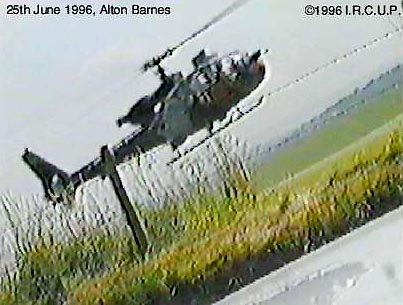 Unidentified helicopter rises from East Field over the barbed wire fence along the road and hovered low over Kerry Blower's car. Video frame isolated from Kerry Blower's June 25, 1996, camcorder tape by Paul Vigay, cropcircleresearch.com.