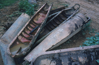 Bombee cases along the road from Xepon to Vilaburi. Photograph © 2001 by Linda Moulton Howe.