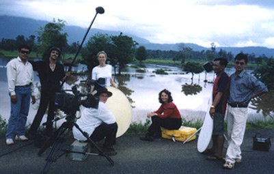 Watery rice fields between Xepon and Vilaburi. Left to right: Phoudoi Travel Co. driver;  Audioman Martin Geissmann from Bangkok, Thailand; Producer Denise Blazek from Perth, Australia; Associate Producer Jacquetta Hayes from Hong Kong; Investigative Reporter Linda Moulton Howe from Philadelphia, Pennsylvania; Lam Sae, Phoudoi Travel; and Soukhasavanh Sanaphay, Press Department, Ministry of Foreign Affairs, Vientiane, Laos. Photograph © 2001 by cameraman Brad Dillon.