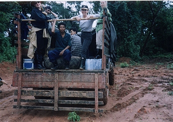 On the rugged road to Vilabouli (Vilaburi), left to right: Producer Denise Blazek from Perth, Australia; Soundman Martin Geissmann from Bangkok, Thailand; a Laotian guide; Soukhasavanh Sanaphay, Vientiane Ministry of Foreign Affairs Press Department; Reporter Linda Moulton Howe; Associate Producer Jax Hayes, Bang Productions Ltd., Hong Kong. Photograph by Videographer Brad Dillon from Hong Kong.