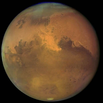 Hubble Space Telescope image of Mars and growing dust storm on October 28, 2005, one night before its close approach to Earth at 41 million miles on October 29, 2005. Image credit: NASA, ESA, The Hubble Heritage Team (STScI/AURA), J. Bell (Cornell University) and M. Wolff (Space Science Institute).