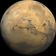 Mars and deep gash of Valles Marinaris, largest canyon in the solar system,by the Hubble Space Telescope.
