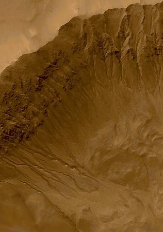 Gorgonum Crater on Mars showing dozens of possible water trails in the red planet crater wall. Photograph courtesy of NASA and Jet Propulsion Lab from Mars Global Surveyor.