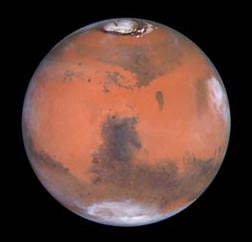 North and south poles of Mars are icy. Photo courtesy Hubble Space Telescope.