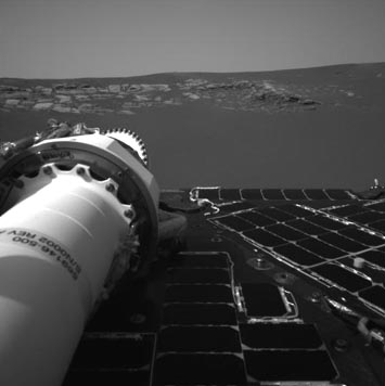 Above and below: Opportunity's panorama camera shows rocky "butte" surrounded by dark "sea of soil" that is thought to be grey hematite, a very different mineral from the iron, olivine and nickel soil that Spirit landed on in the Gusev crater. Image: NASA/JPL.