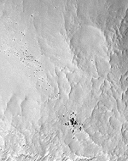 Scattered 80-foot dark boulders - from where? Nilosyrtis Mensae Valleys, mid-Martian latitude. High resolution image is 3 kilometers wide by 4.9 kilometers vertical (1.9 miles by 3 miles) taken on February 14, 2001 by the Red Rover Goes to Mars International Student Training Mission. Image courtesy of NASA/JPL/Malin Space Sciences Systems.