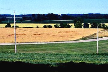 View from Art Rantala's workshop in Mayville, Wisconsin, of the three circles he allegedly saw go down one after the other over a time span of about 15 seconds in the wheat field across the road. It was raining, but no wind or thunderstorm. Photograph © 2003 by Jeffrey Wilson.