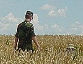 USAF man who identified himself to Jeffrey Wilson and Roger Sugden in the July 2003 Mayville, Wisconsin, wheat formation as being a member of a "Special Crop Circle Investigative Unit in the US Air Force," that had been looking into this Mayville formation for a couple of weeks, temporarily based out of a hanger in Milwaukee. Photograph © 2003 by Jeffrey Wilson and Roger Sugden.